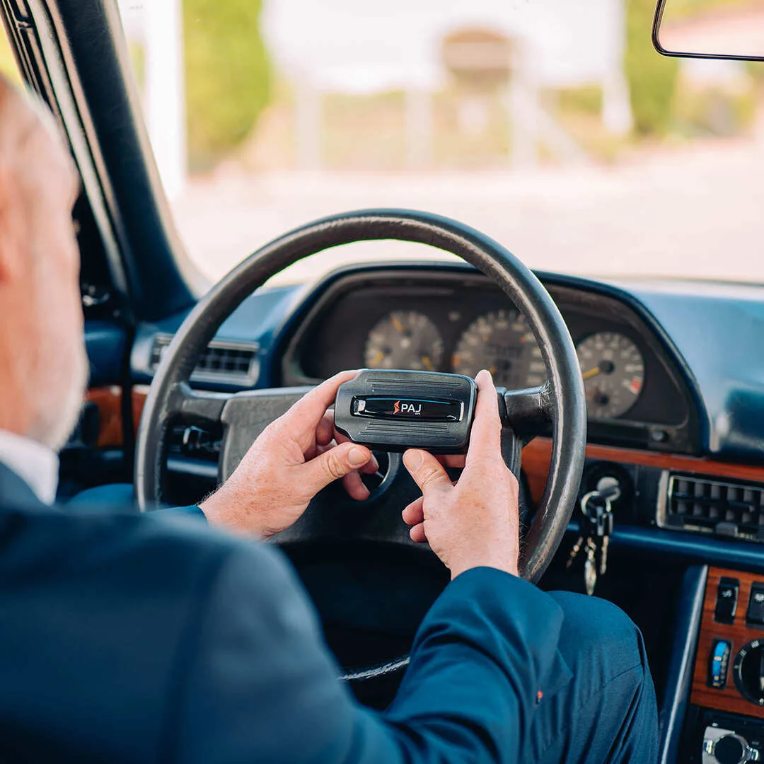 A man holding PAJ GPS POWER Finder 4G GPS Tracker