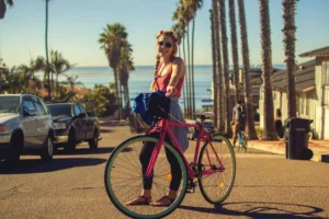 A girl standing beside her bike
