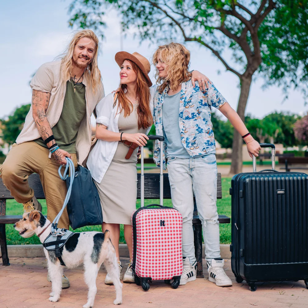 A family having GPS tracker placed in their luggage posing for a group photo before starting the journey