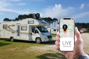 Motorhome in the background and phone in the foreground, where the live location of the motorhome displayed