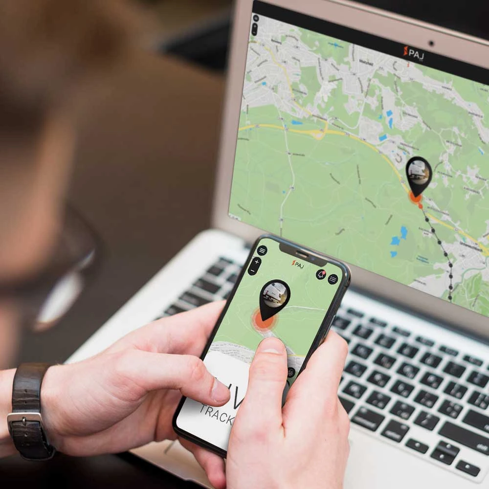 A phone and a laptop screens showing finder portal application from paj gps to track vans online