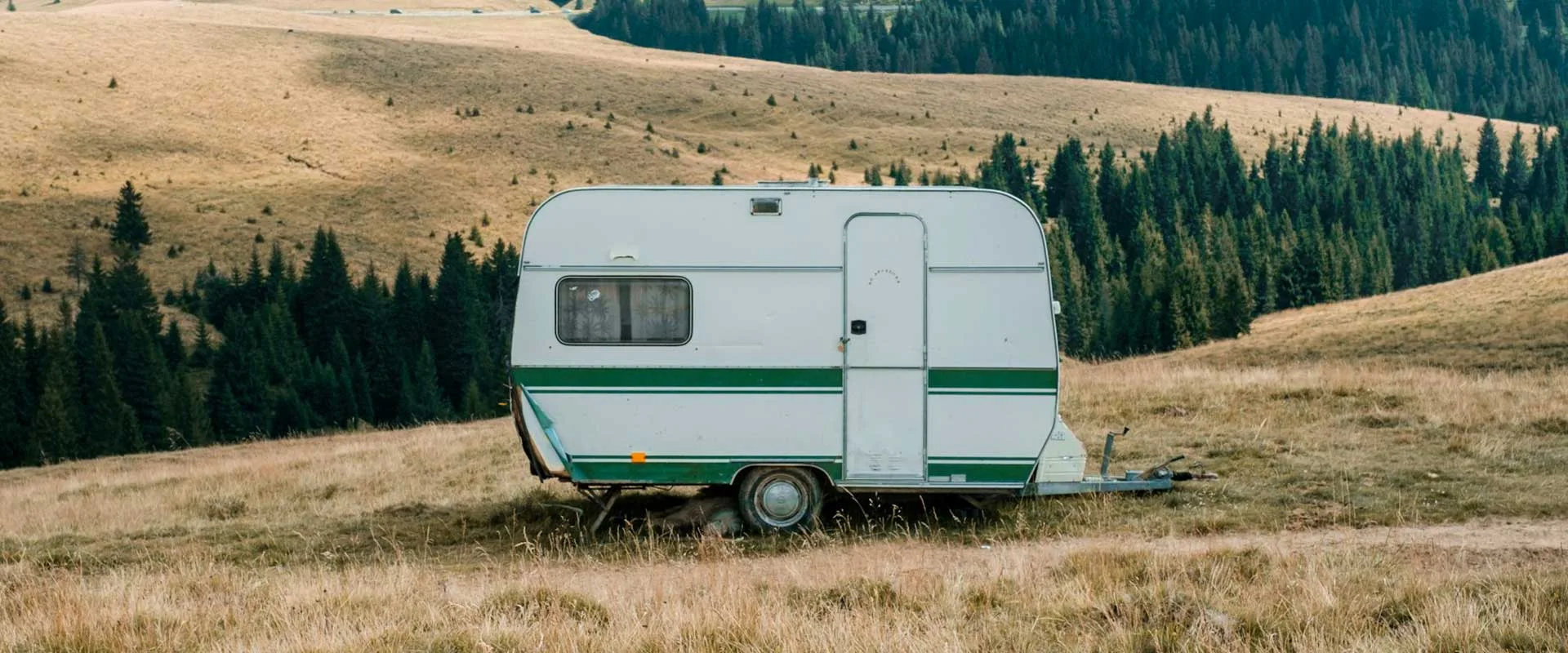A caravan near a haystack landscape