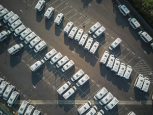 delivery trucks parked in a huge parking lot