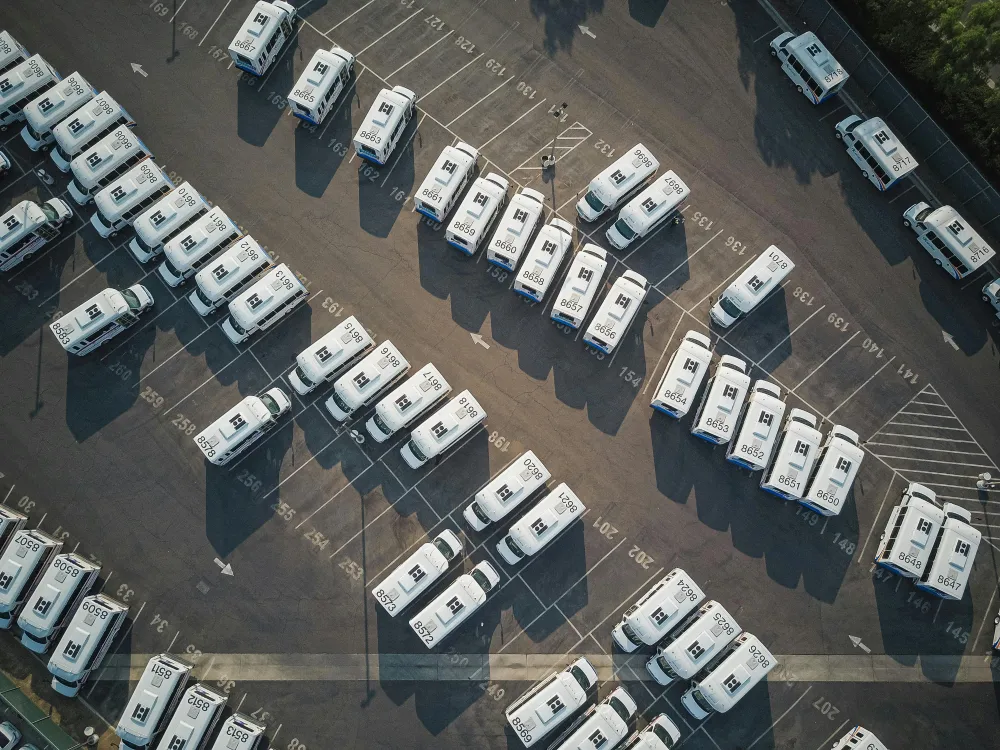 delivery trucks parked in a huge parking lot