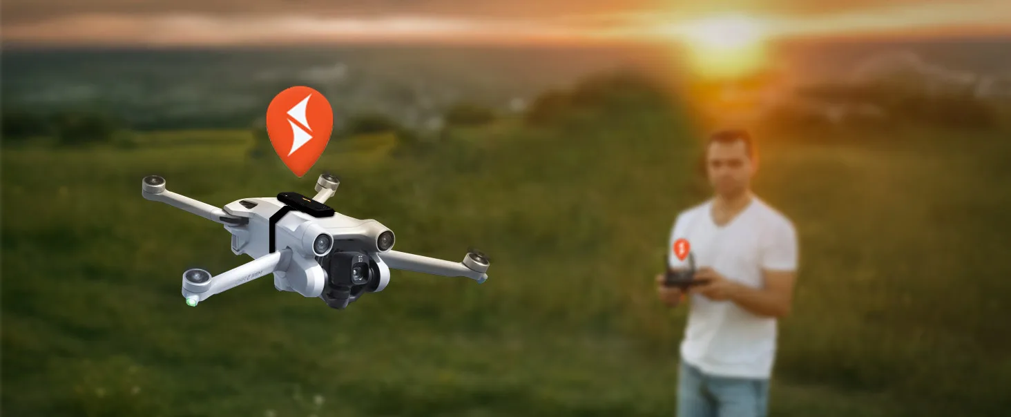 drone tracker installed in a mini drone which is flying in an open feild by a man